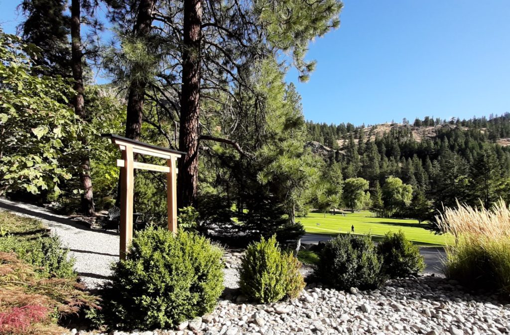 St. Andrews by the Lake BC Canada, sunlit torii gate leading into a gravel path, composed to emphasize harmony between built and natural forms – Constructed by George Wendell Baker